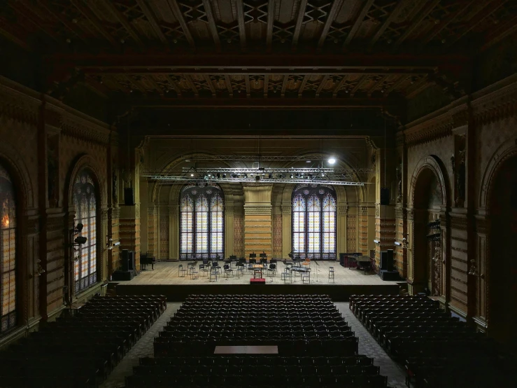 an empty church with a stage and a set of benches