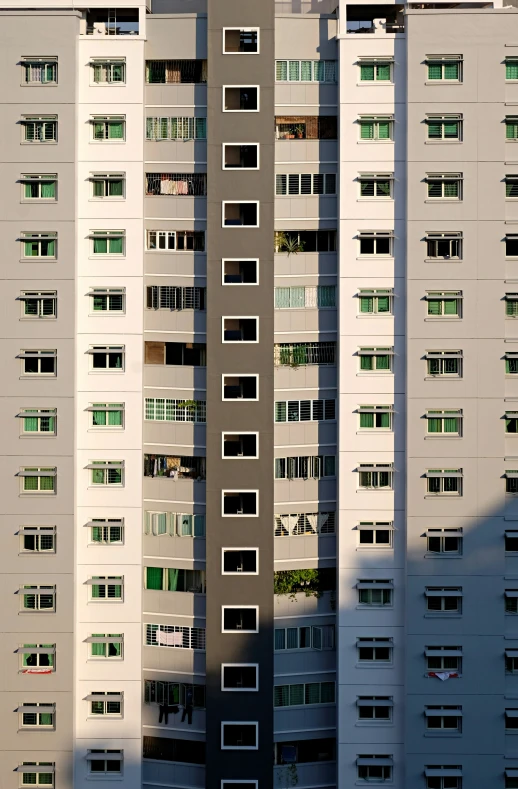 tall buildings with windows and balconies along side a street