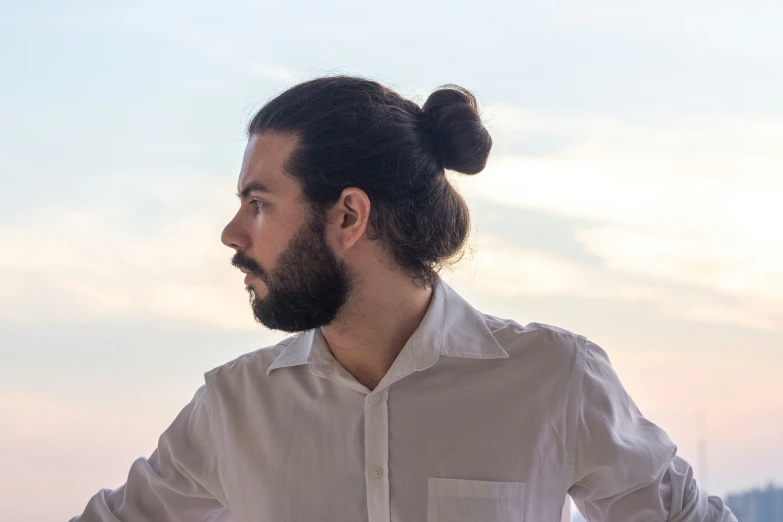 a man with a bun on top of his head