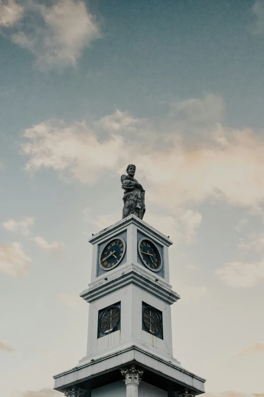 a clock tower with two clocks on each side and a sky background