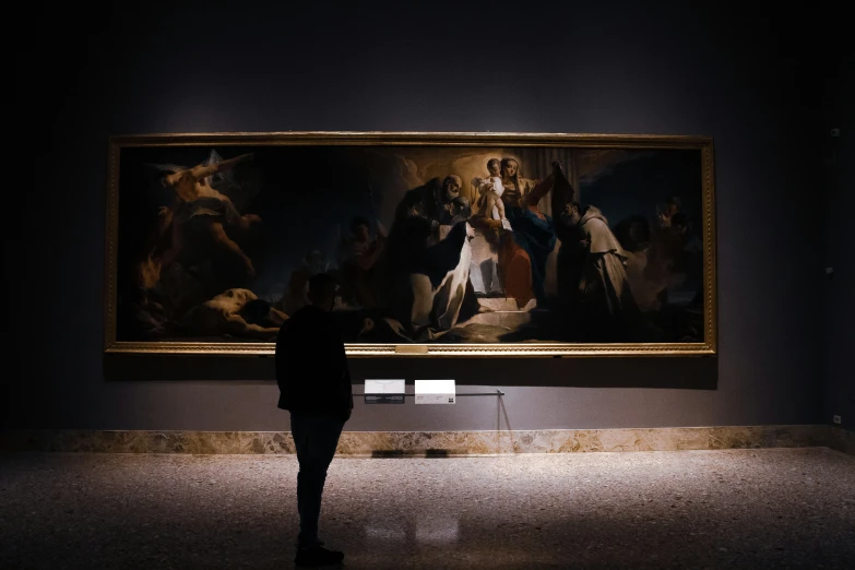 a person stands in front of a painting