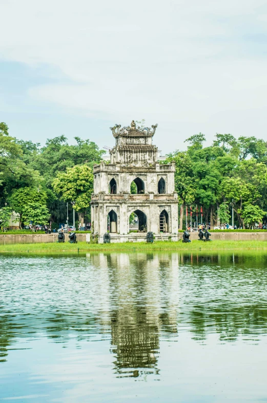 the palace is situated near water in front of trees