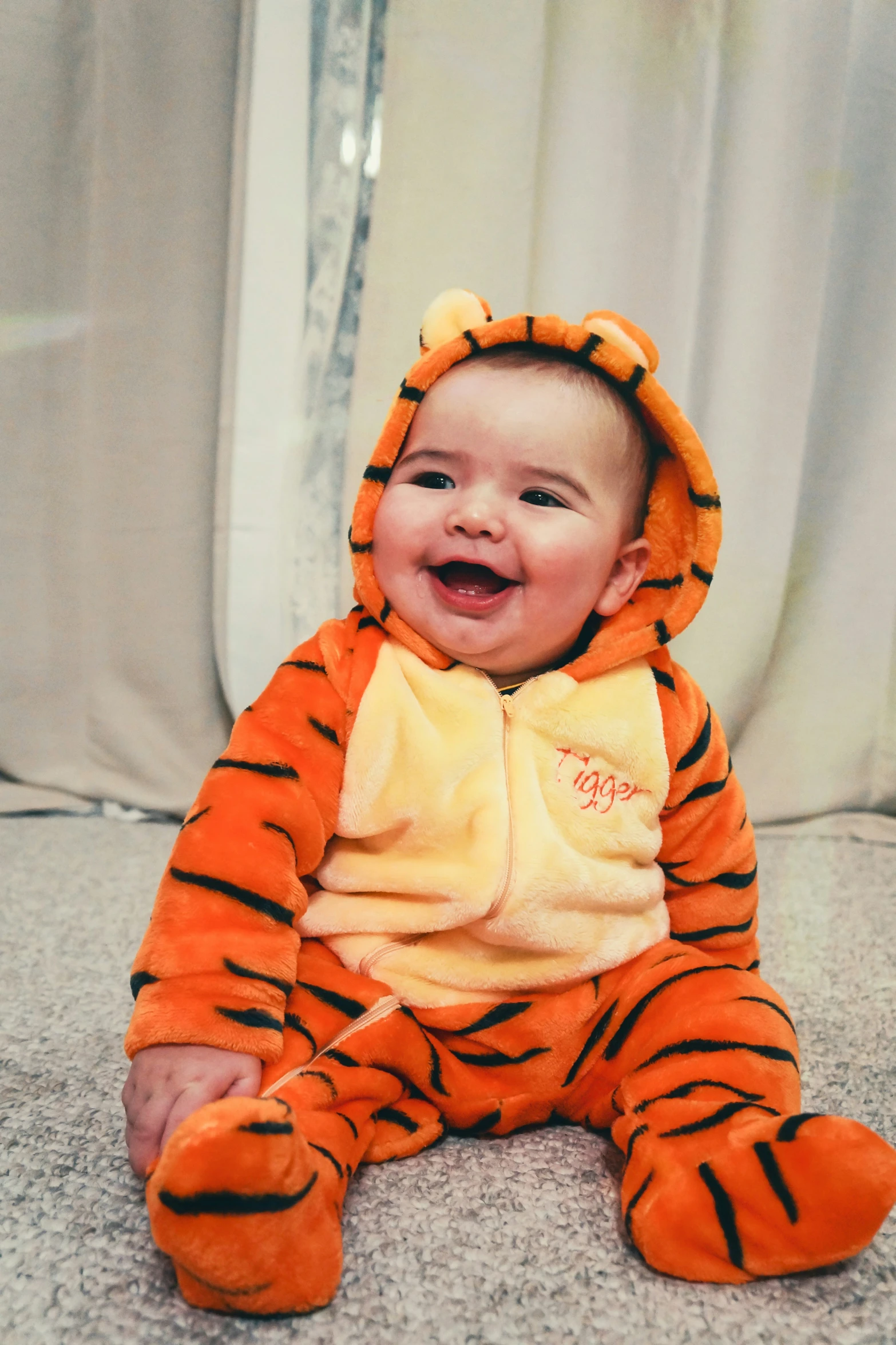 a smiling baby dressed in a tiger costume