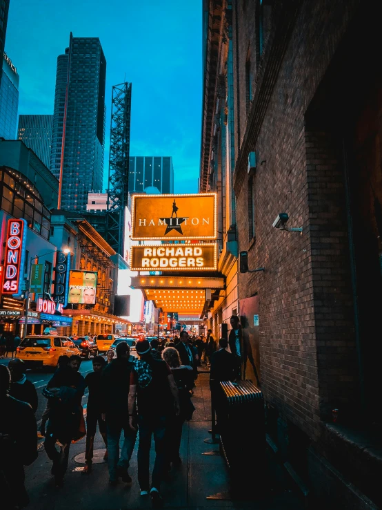 a group of people walking down a dark city street