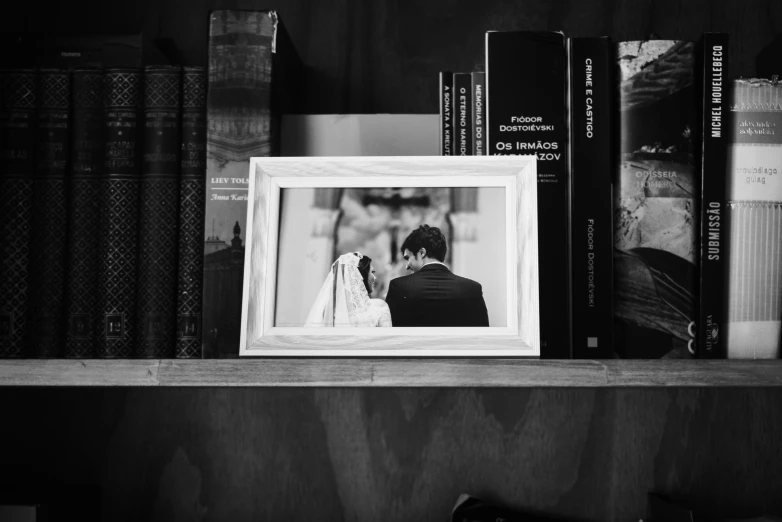 a po of two people on a bookshelf