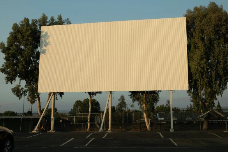 a large billboard has three white poles on the top