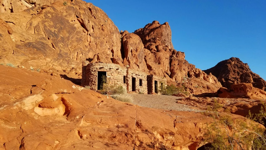 an ancient stone hut nestled on top of a rocky hill