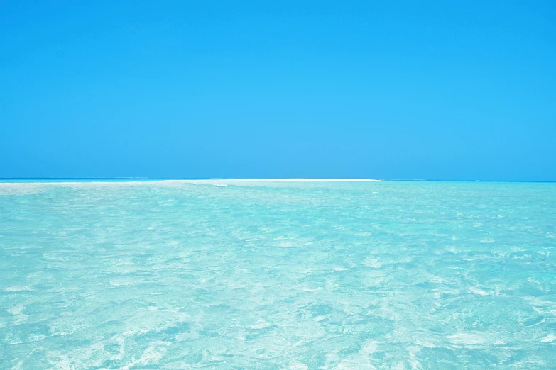 a person paddling in the ocean with a surfboard