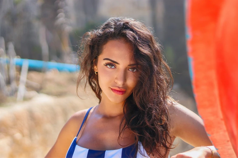 a woman is posing for the camera in her bikini