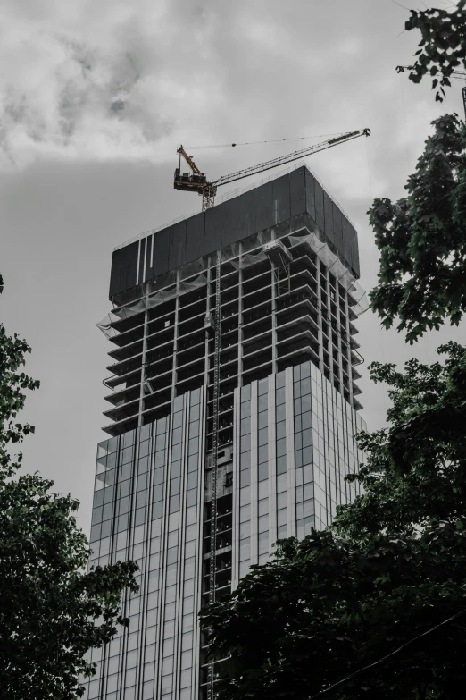 the crane is hanging on top of the building