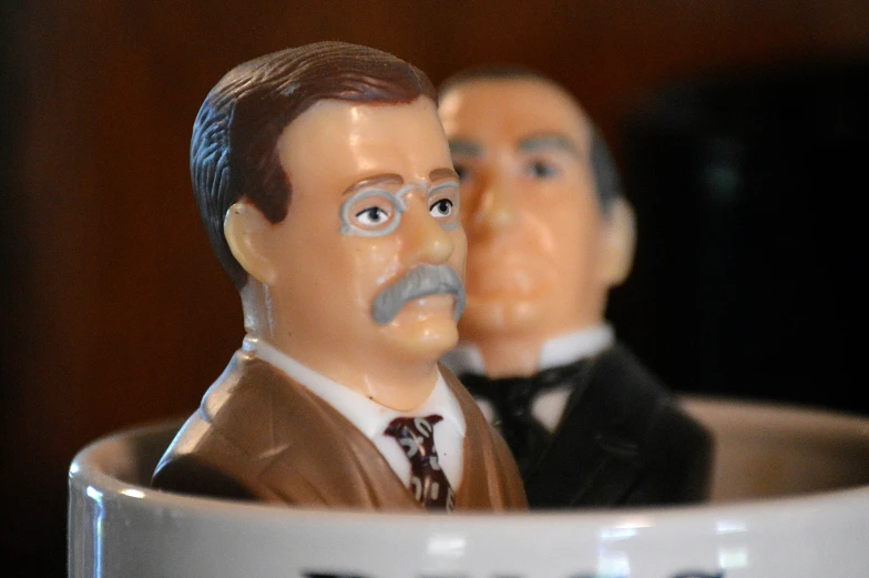 two small figurines wearing suits and ties