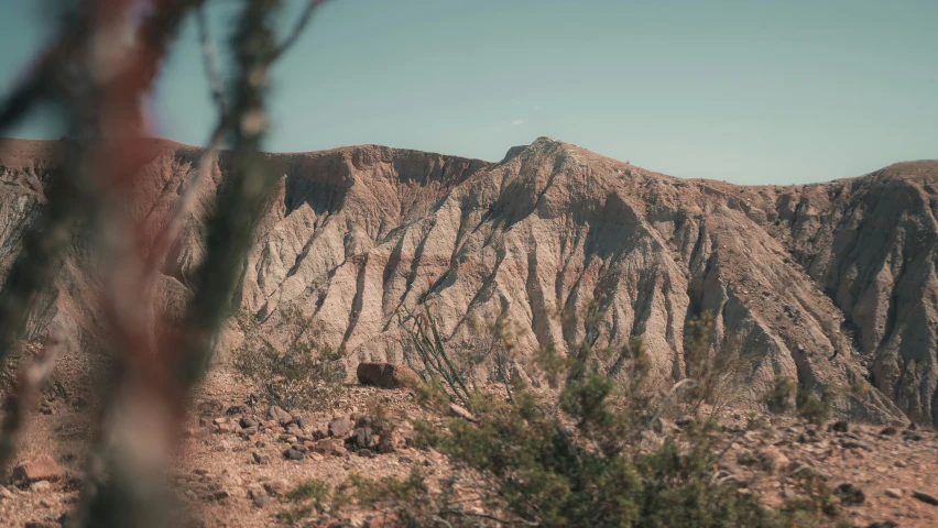 the mountains are brown in color against the blue sky