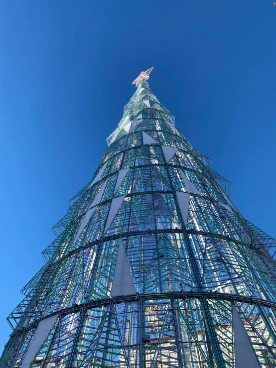 looking up at the top of a glass christmas tree