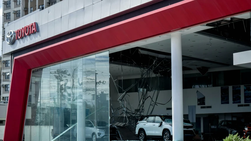 car with a smashed glass window parked near building