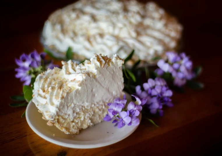 some purple flowers near two pies sitting on a table