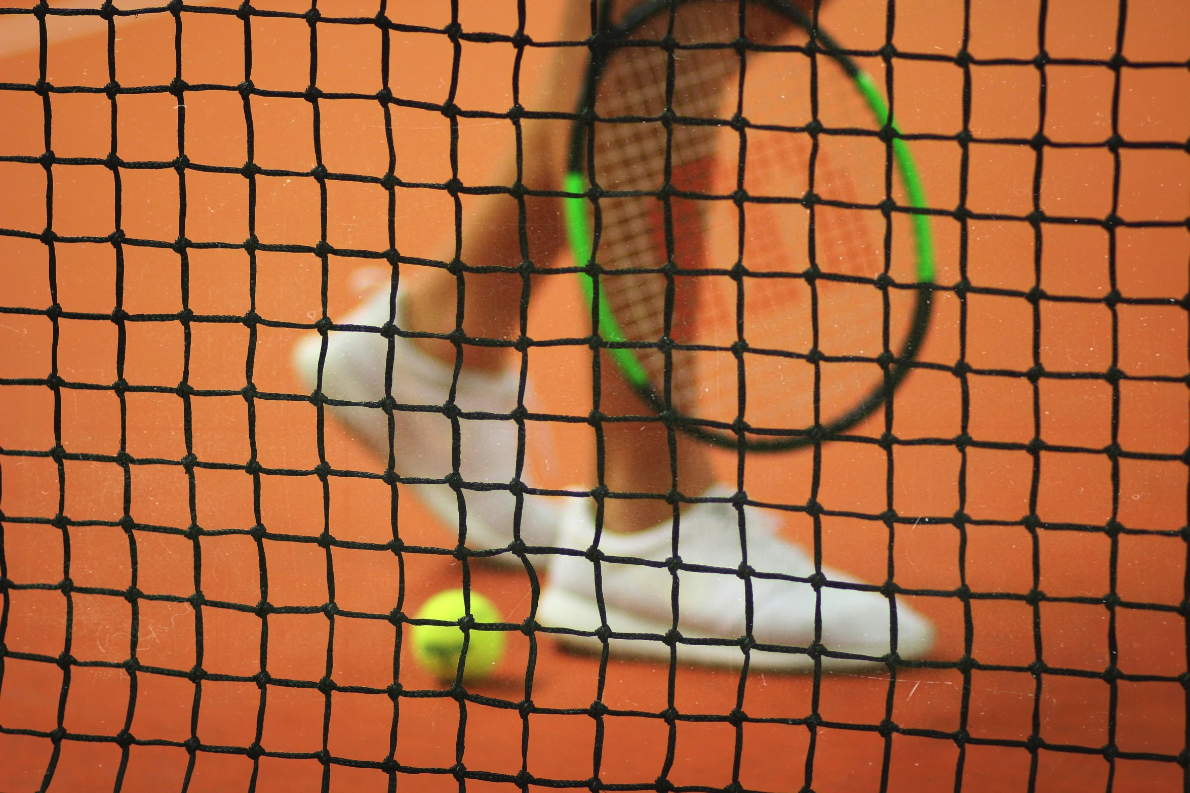 the tennis racquet is resting on the net