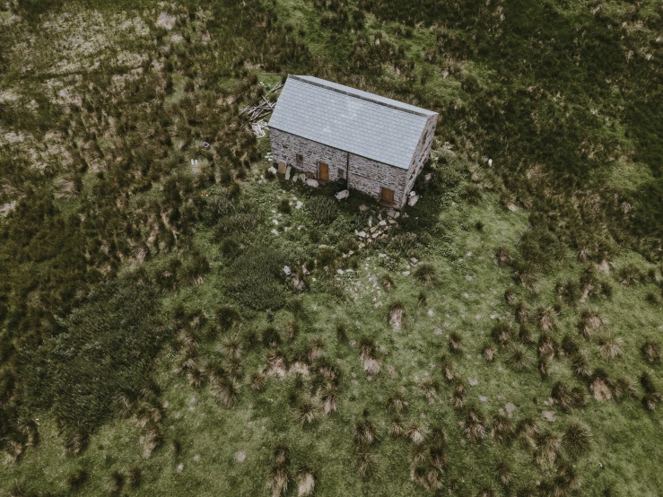 an aerial po of a building in a field