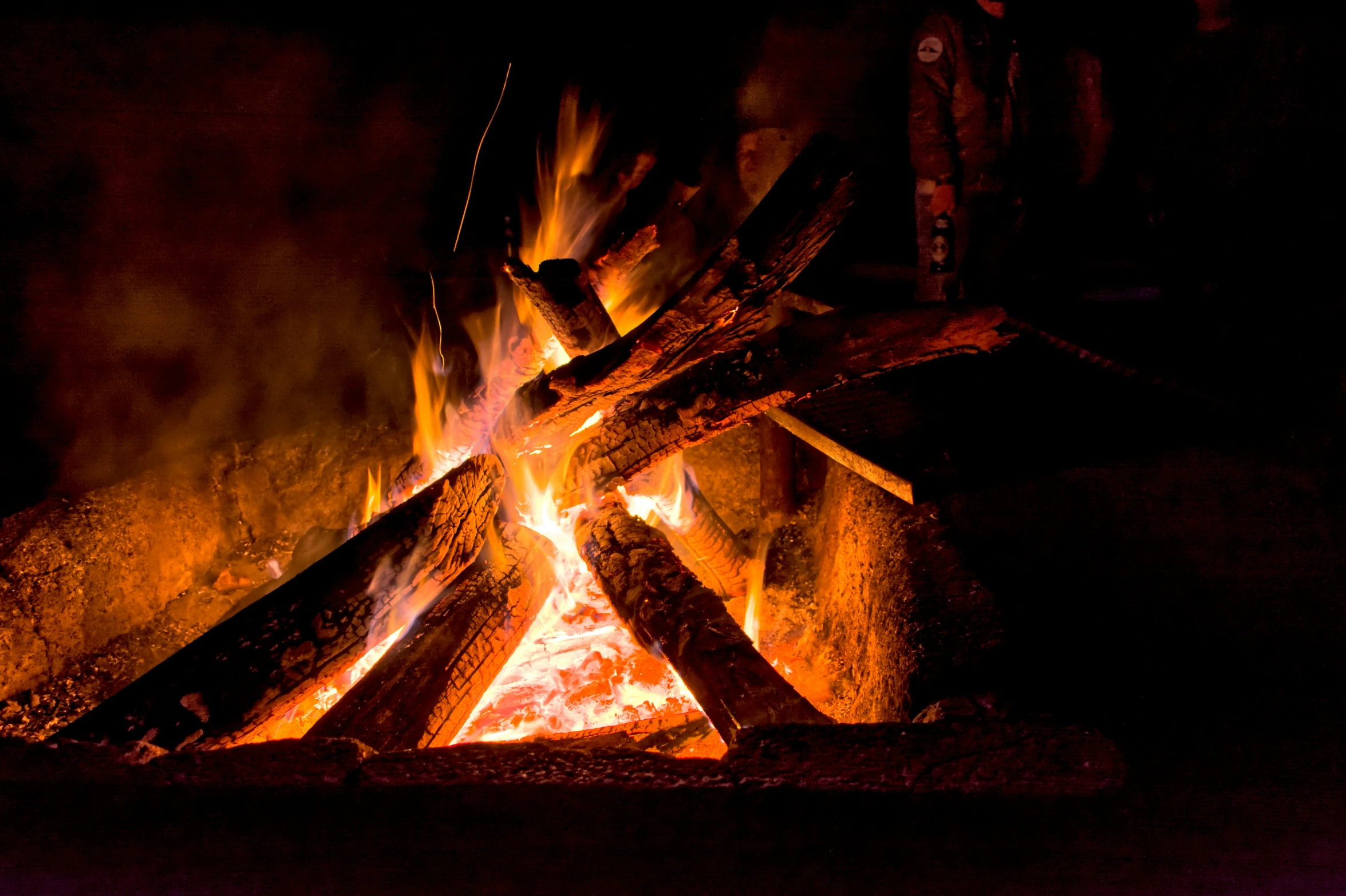 a fire pit with wood burning in it