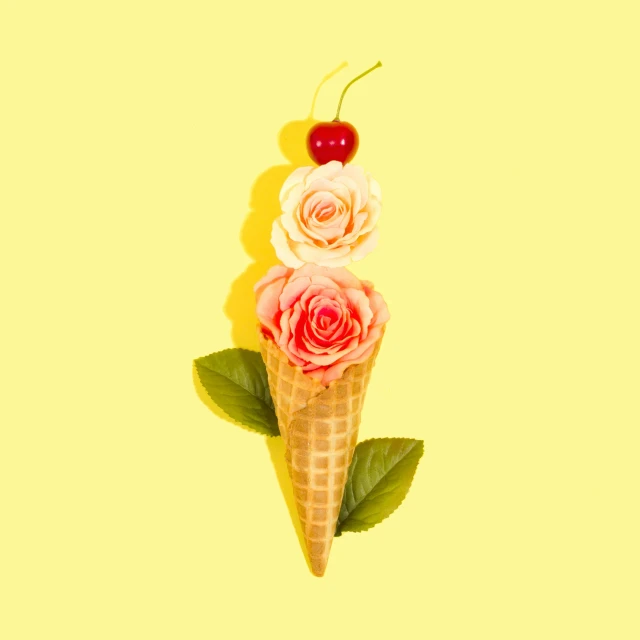 three ice cream cones with roses on top