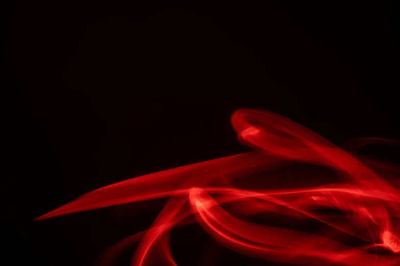 a red object that appears to be blurry against a dark background