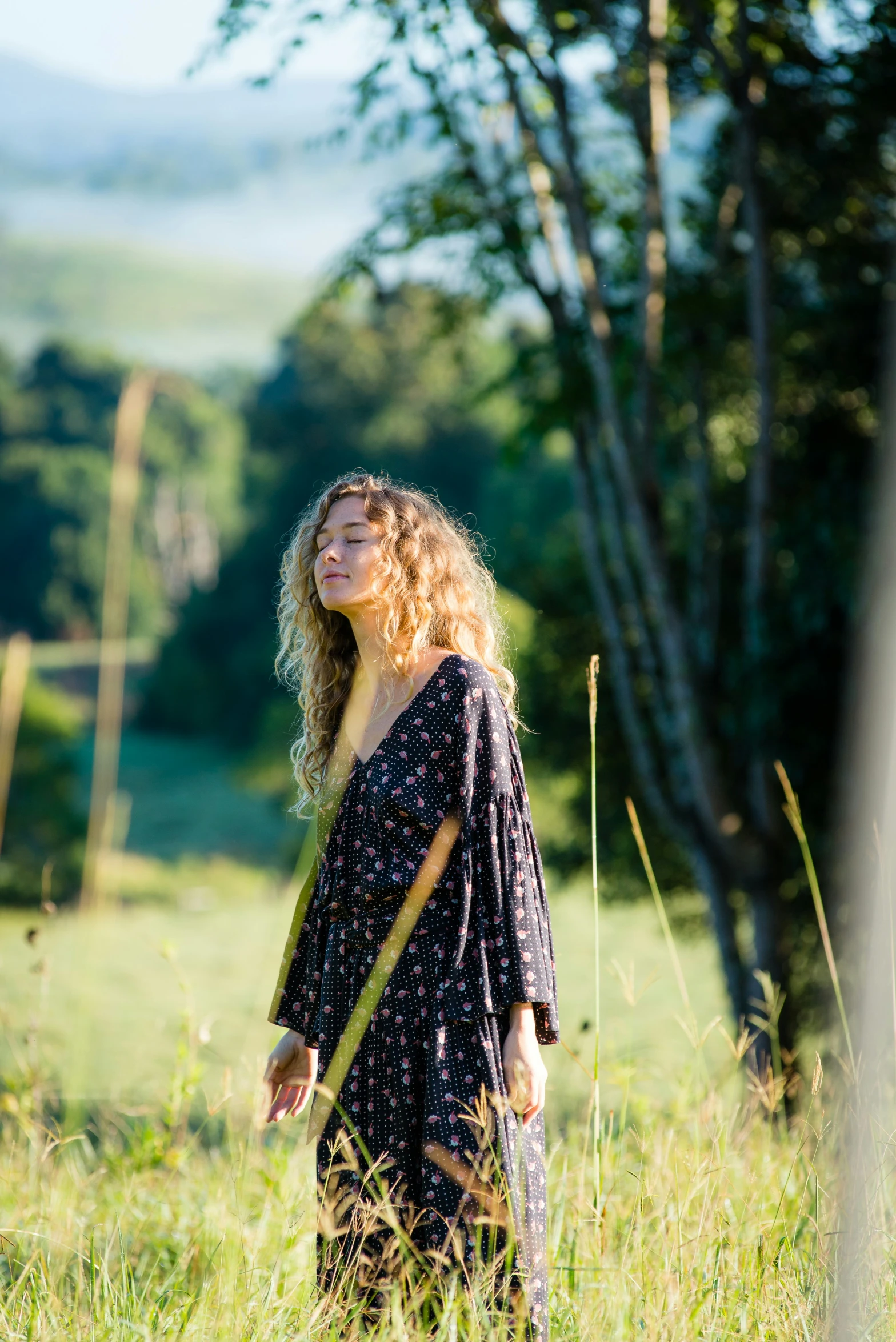 the woman has her eyes closed in the grass