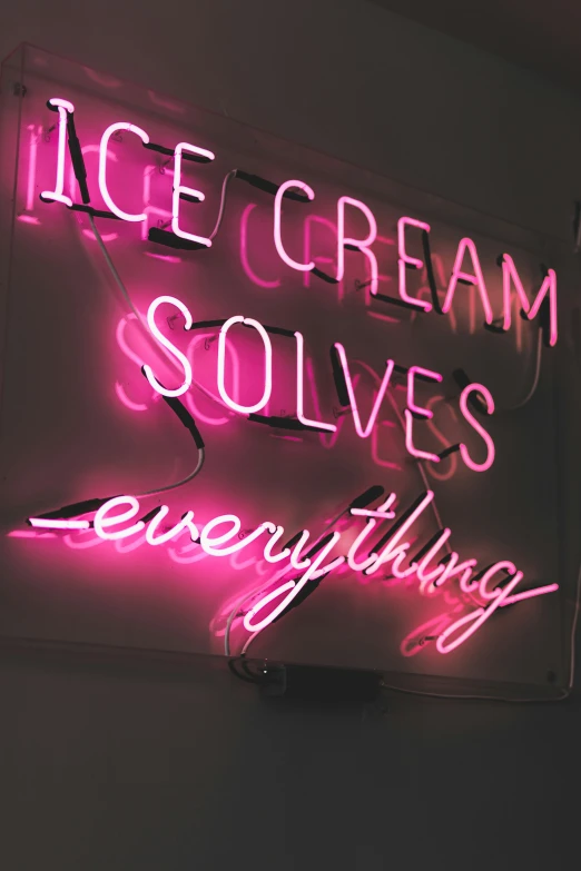 a neon sign advertising ice cream solves everything