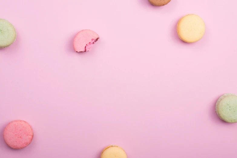 a table topped with macarons covered in frosting