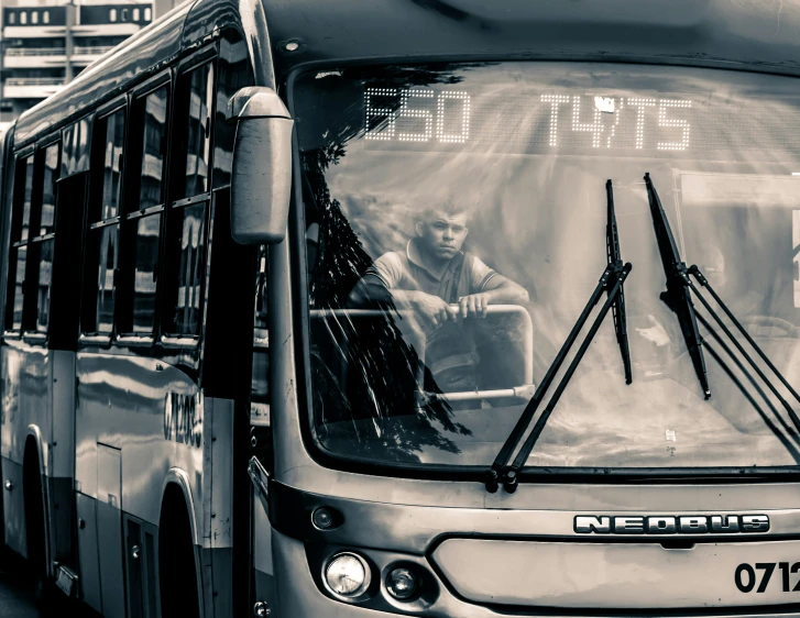 the driver and passenger are sitting in their bus