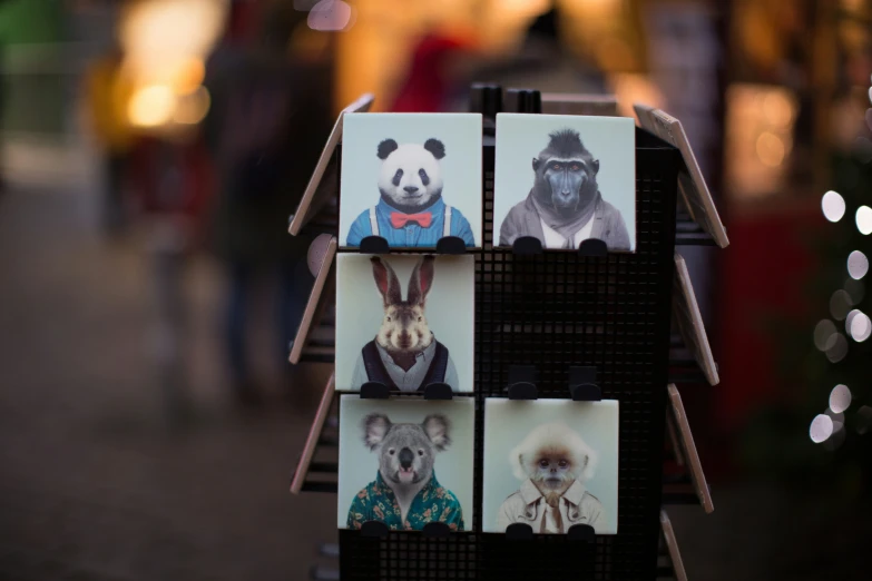 some animals are on pictures displayed in front of a christmas tree