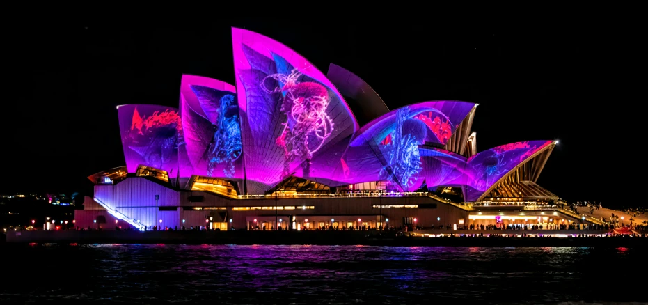 colorful lights show on the exterior of the opera