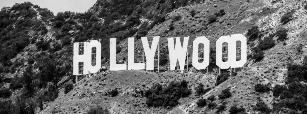 a large hollywood sign that is hanging on the side of a mountain