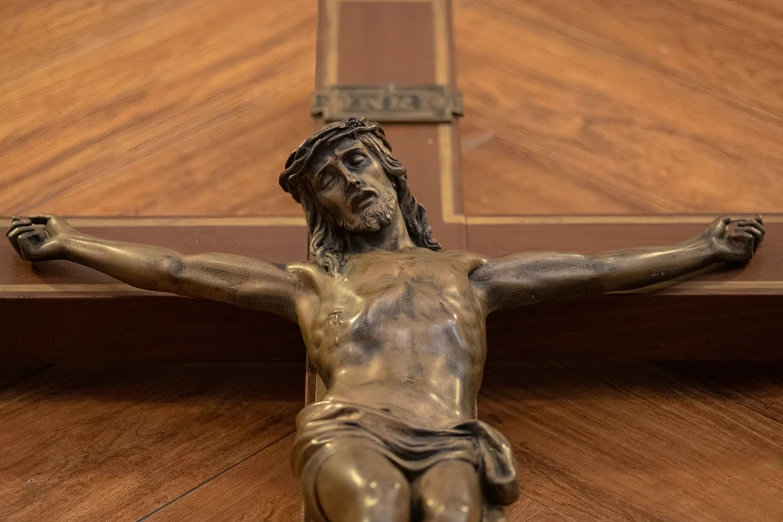 the statue of jesus is on a wooden shelf