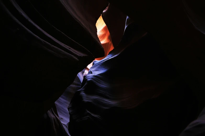 a canyon with light coming out in the corner