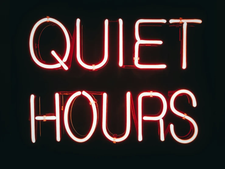 there is a neon sign with the words quiet hours