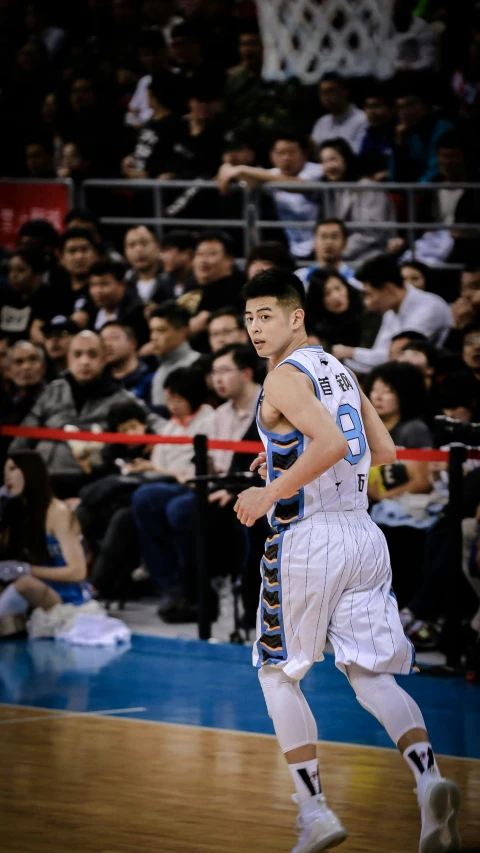 a man wearing a white uniform is playing basketball