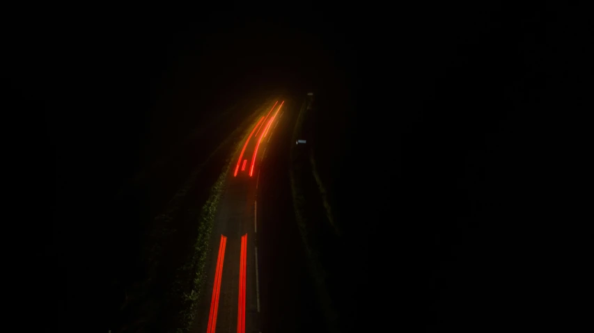 traffic lights in the night along side of a street