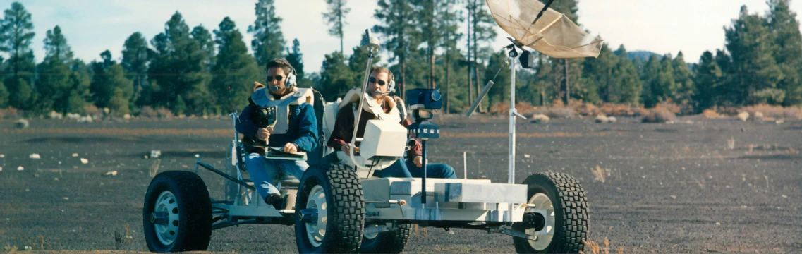 two people are in a vehicle with wheels and tires