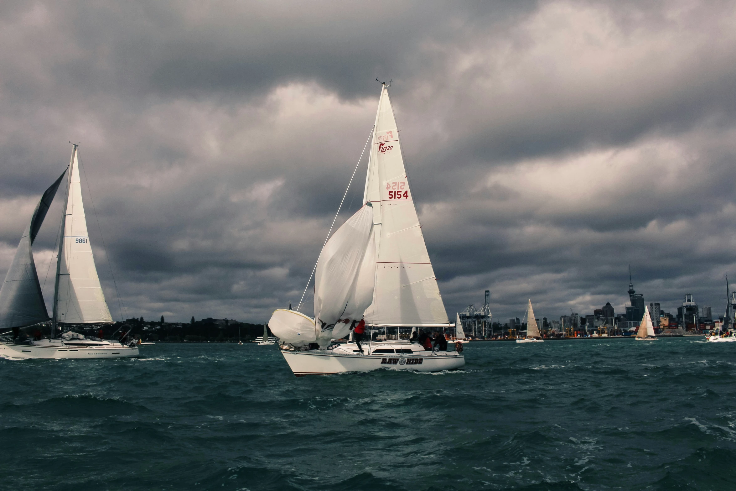 a group of sail boats racing through the water