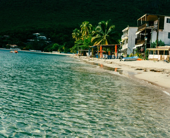 there is water that is next to the houses on the beach