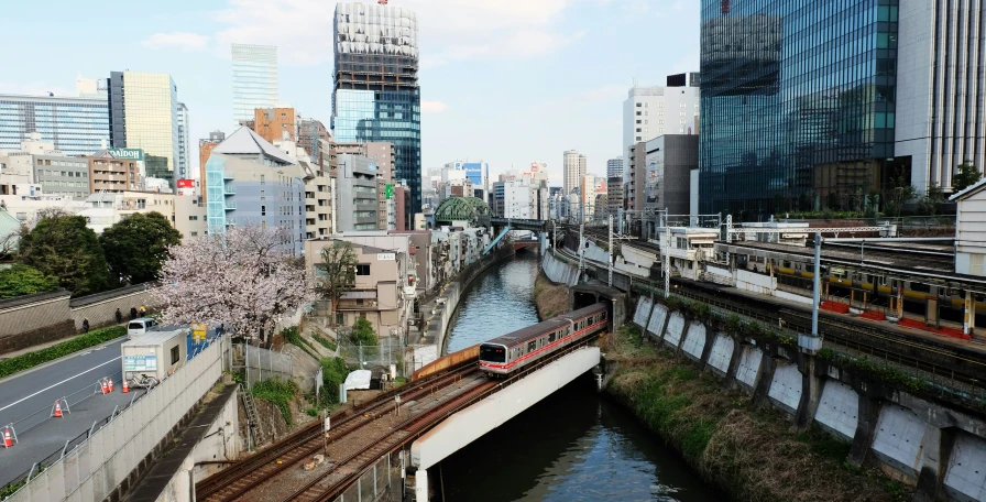 there is a long train going across a bridge