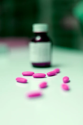 a bottle of pills sitting on top of a white table