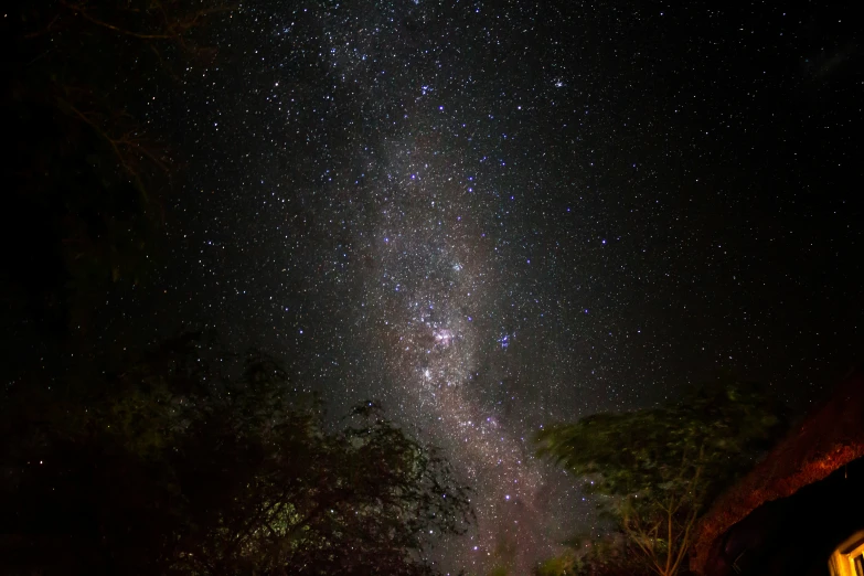 a man is standing outside while looking up at the stars