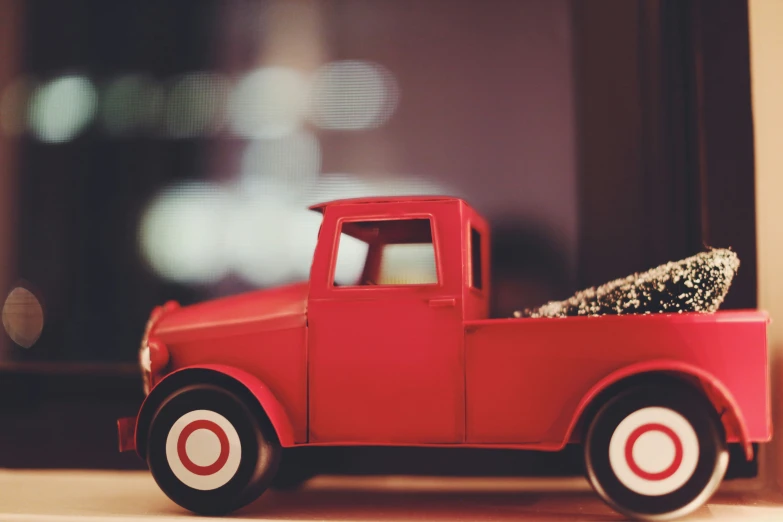 a toy truck with a christmas tree on the side