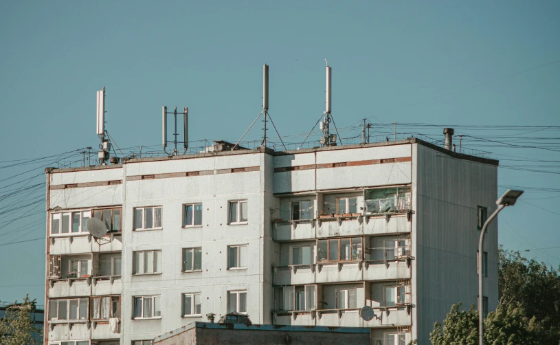 an apartment building with antennas atop