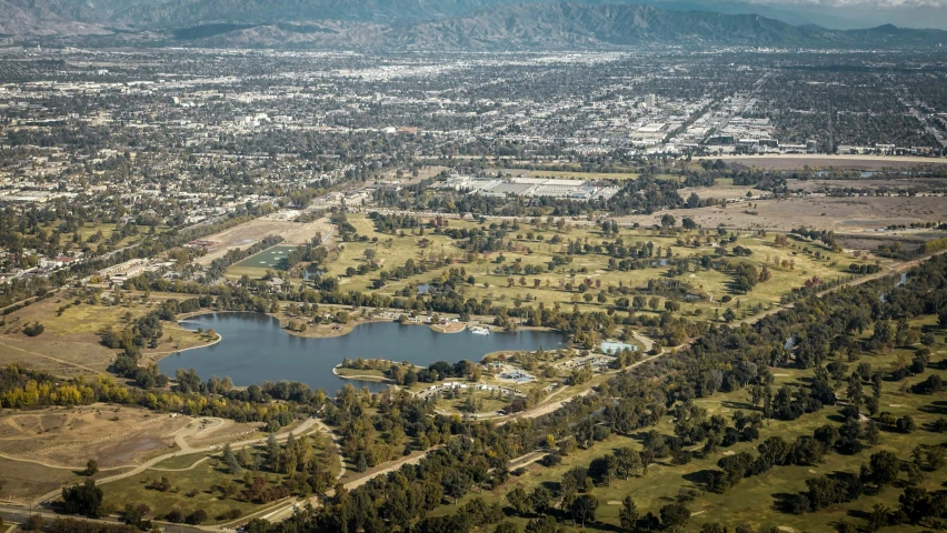 the town is on a hill surrounded by water and trees