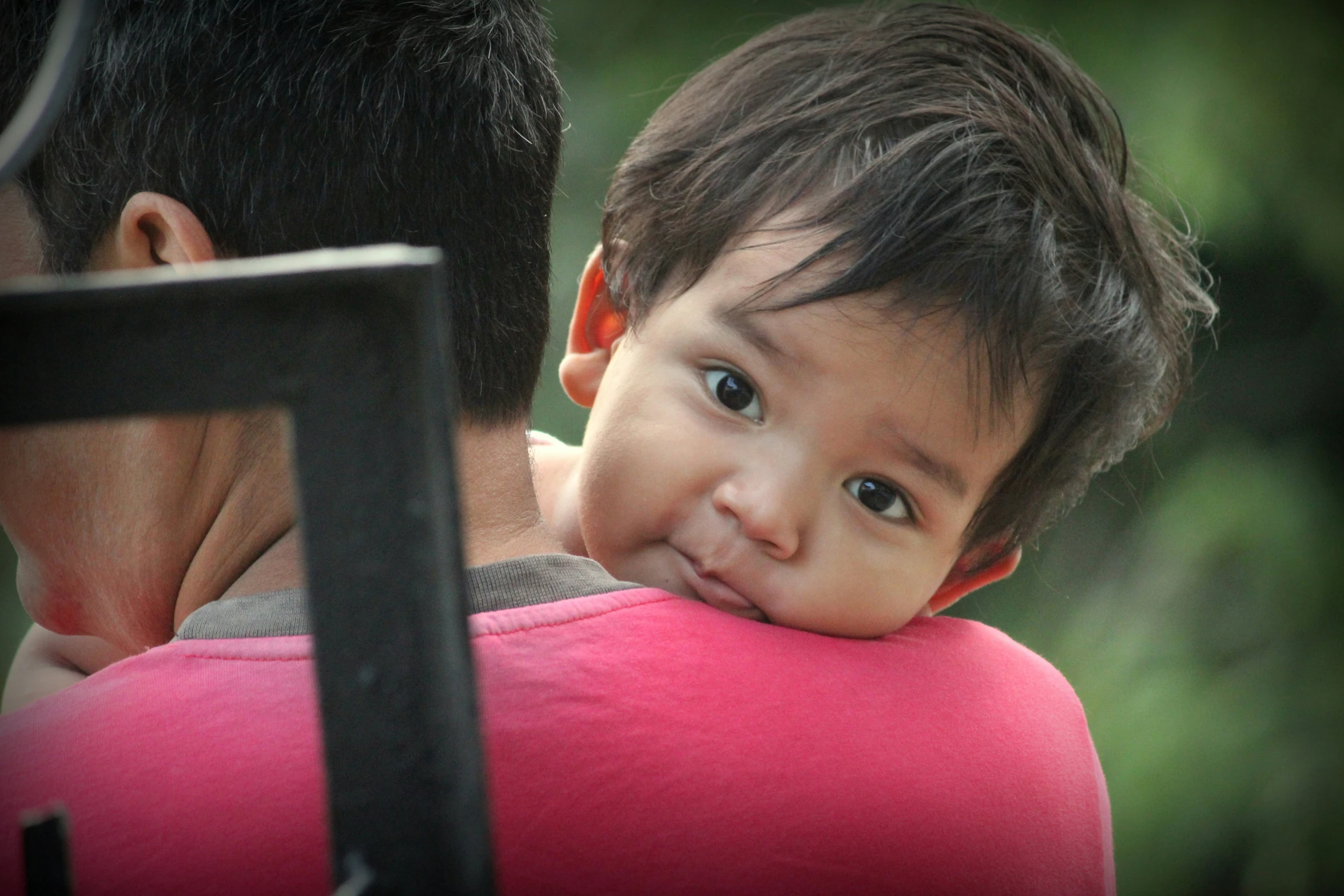 a small child and an adult looking at each other