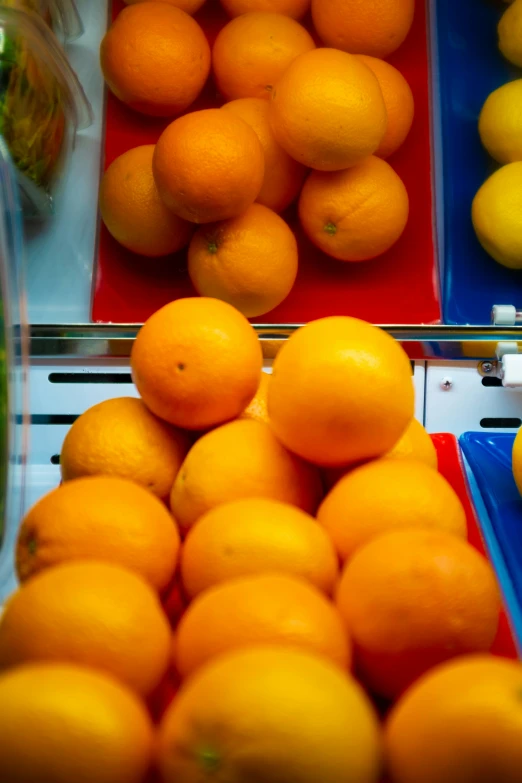 a pile of oranges in containers on top of a table