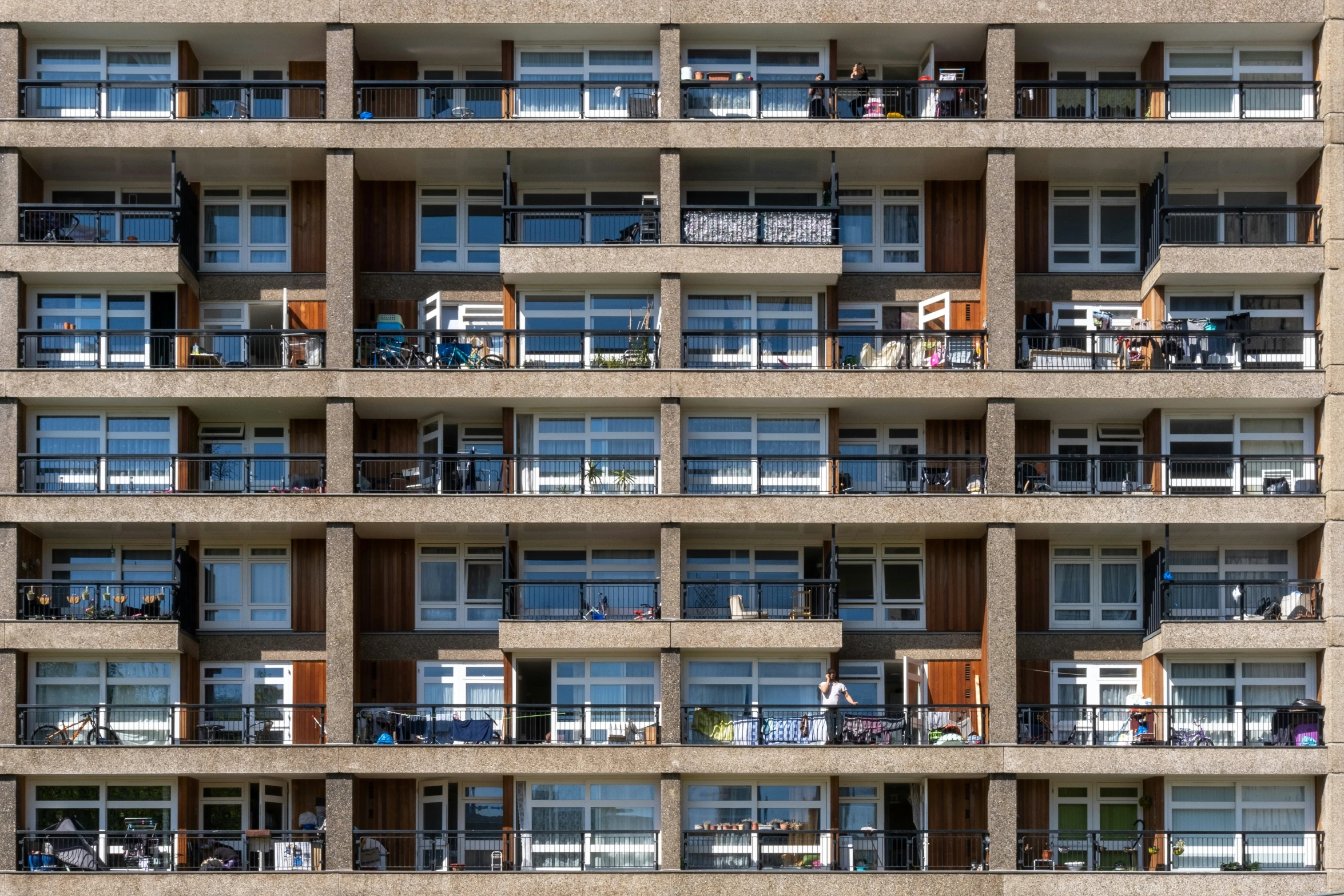 a tall building with multiple balconies that have windows open and balconies in them