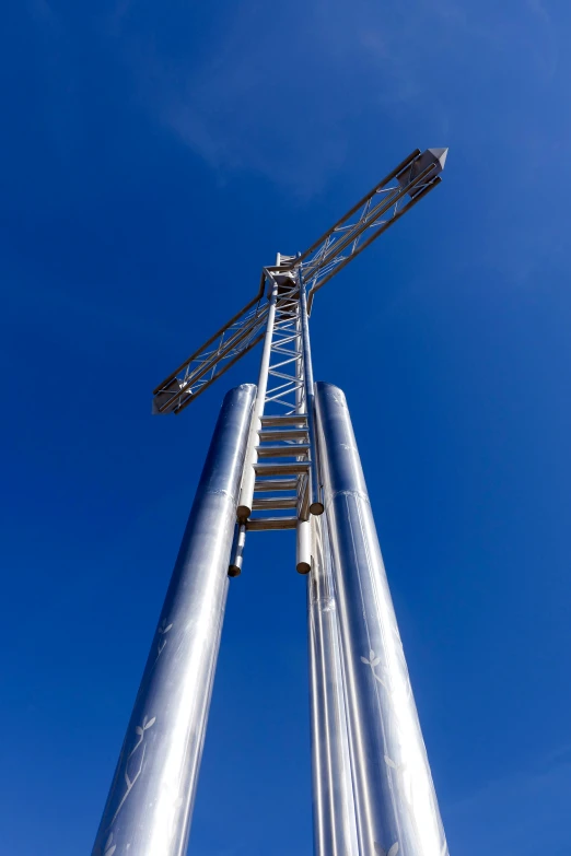 a couple of tall metal structures on a field