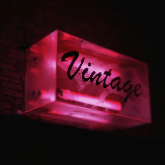 illuminated display case showing the word vintage in a city